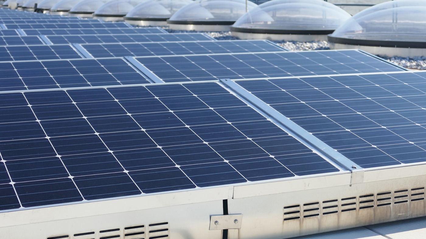 Rows of solar panels installed on a commercial rooftop