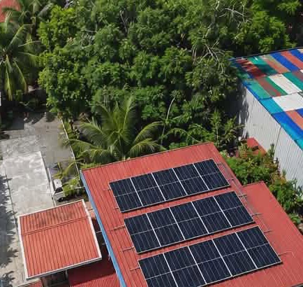Aerial view of solar panels installed on a red roof in Brgy. Linintian, Cantilan